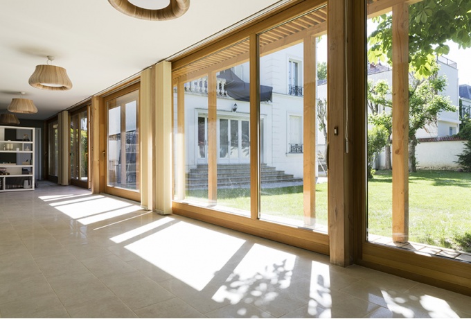 Particulièrement modulable, l'intérieur est totalement ouvert sur le jardin, duquel les habitants peuvent s'isoler en fermant les rideaux.<br/> Crédit photo : Dureuil Philippe